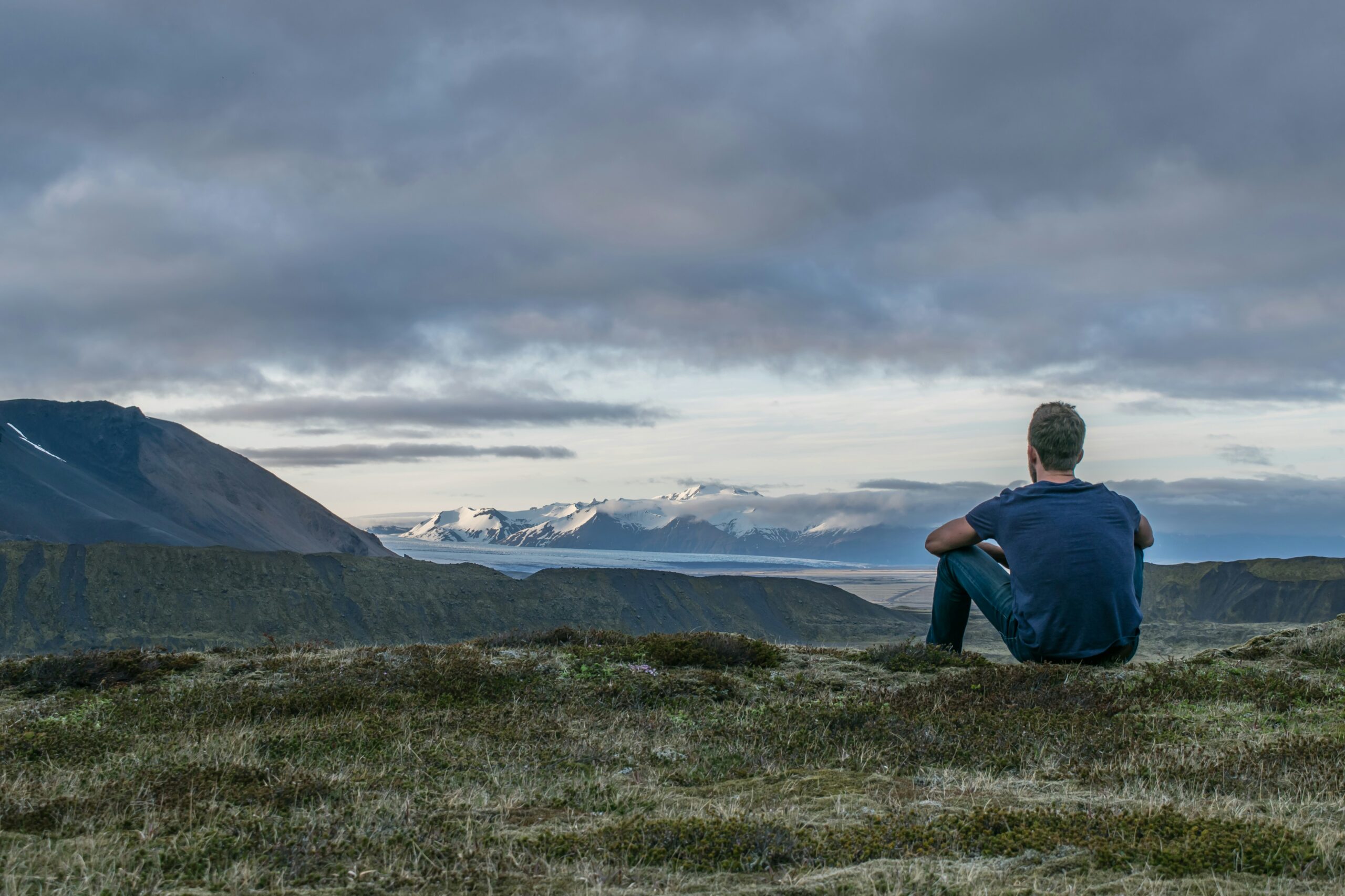 man sitting on a cliffside