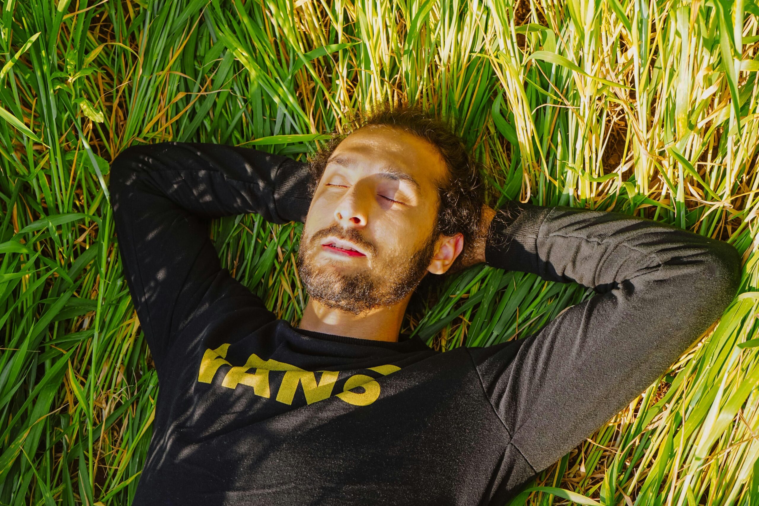 man lying in the grass calm